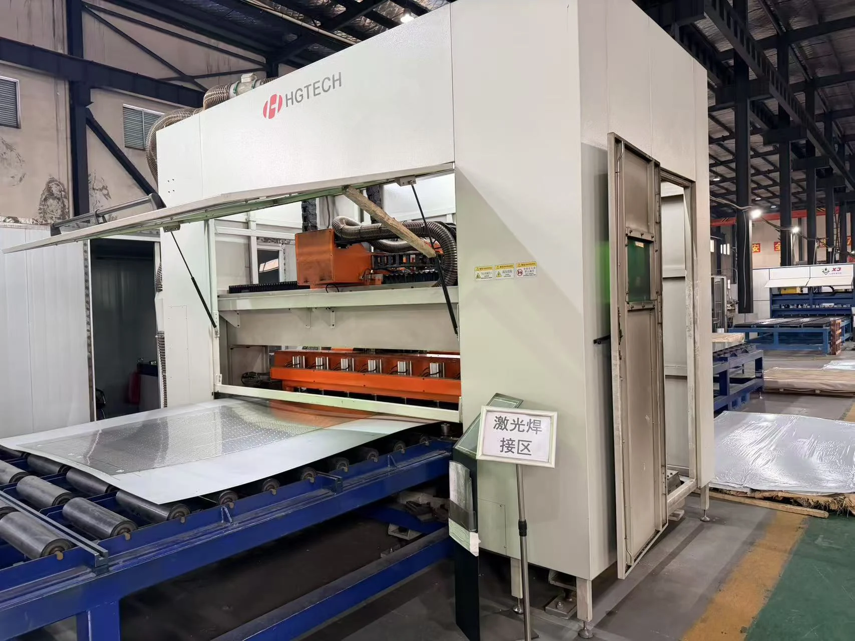 Pillow plate sheets entering the automated laser welding station